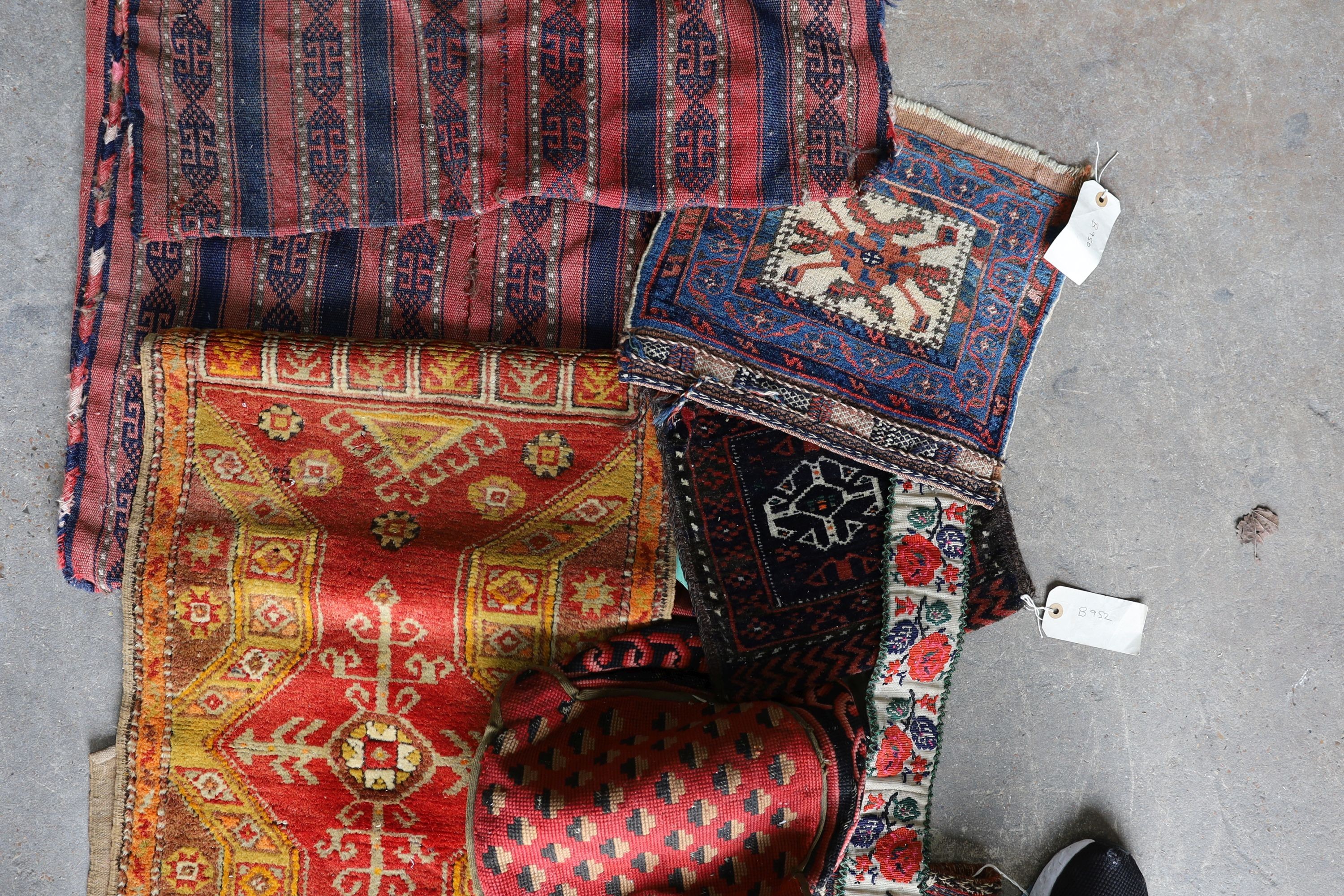 An Afghan Kilim flatweave saddlebag, 144 x 69cm together with six assorted bags, faces, etc.